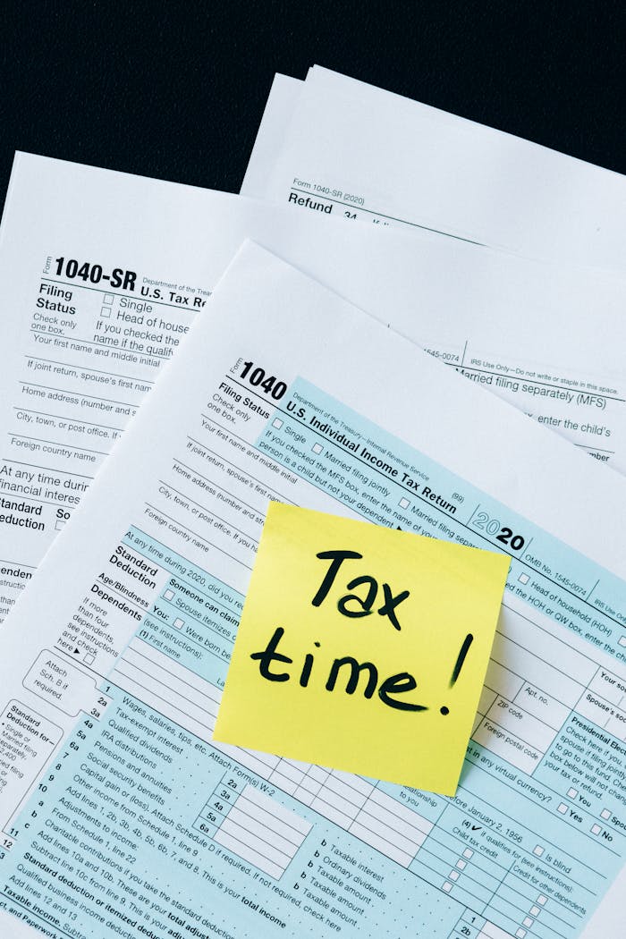 services-02 IRS 1040 tax forms with handwritten 'Tax Time!' note for filing reminder.